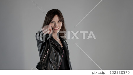 Rocker woman pointing finger at you with smiling expression 132588579