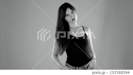 Young woman posing with hands in pockets, black and white portrait Young woman posing with hands in pockets, black and white portrait 132588594
