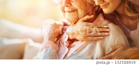 Generations love young woman hugging elderly woman family connection 132588919
