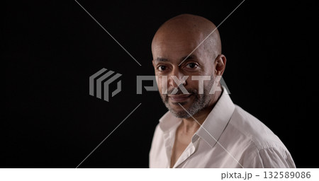 Confident african american businessman posing on dark background Confident african american businessman posing on dark background 132589086