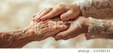 Elderly and young hands together compassion and family support concept 132589133