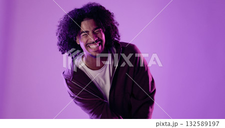 Young man laughing out loud with purple background Young man laughing out loud with purple background 132589197