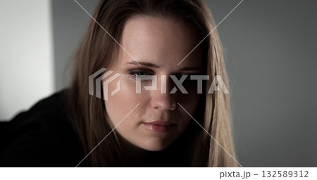 Sad woman looking down with crying eyes suffering from depression Sad woman looking down with crying eyes suffering from depression 132589312