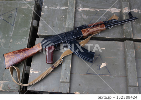 Kalashnikov AK 47 gun on army green crates Kalashnikov AK 47 gun on army green crates 132589424