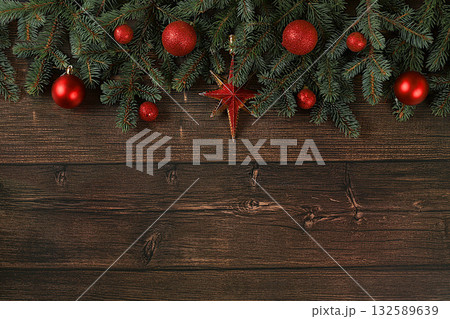 Christmas and New Year 2024 background with blue fir branches with holiday decorations on a dark wooden table, banner for holiday screen, template for design. Holiday card, selective focus, 132589639