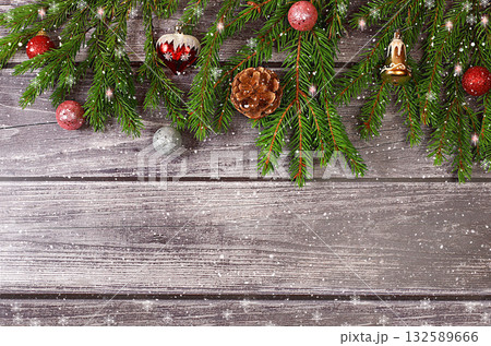 Christmas and New Year 2024 background with fir branches covered with snowflakes on a wooden table, toys and decorations, banner for holiday screen, template for design. Holiday card, selective focus, 132589666
