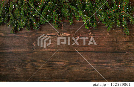 Christmas and New Year 2024 background with fir branches covered with snowflakes on a wooden table, toys and decorations, banner for holiday screen, template for design. Holiday card, selective focus, 132589861