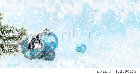 Christmas and New Year mockup for design, screen banner, festive composition with fir branches, cones and decorations on a snowy blue background with place for text, postcard, selective focus Christmas and New Year mockup for design, screen banner, festive composition with fir branches, cones and decorations on a snowy blue background with place for text, postcard, selective focus 132590155