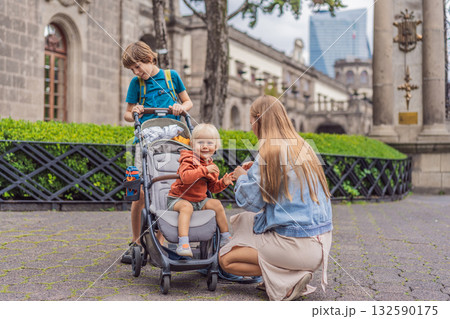 Mother with her two sons standing near Chapultepec Castle in Mexico City, enjoying sightseeing and family travel. Cultural heritage and tourism concept Mother with her two sons standing near Chapultepec Castle in Mexico City, enjoying sightseeing and family travel. Cultural heritage and tourism concept 132590175