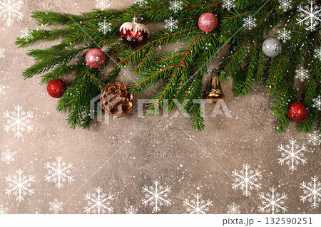 Christmas and New Year 2025 background with fir branches in snow flakes, toys and decorations, banner for holiday screen, template for design. Holiday card, selective focus, 132590251