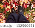 Feet in black shoes standing on autumn leaves fall nature background Feet in black shoes standing on autumn leaves fall nature background 132590951