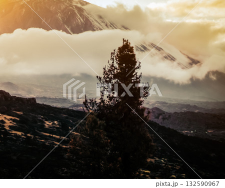A volcano Teide and mountains among clouds at sunset. 132590967