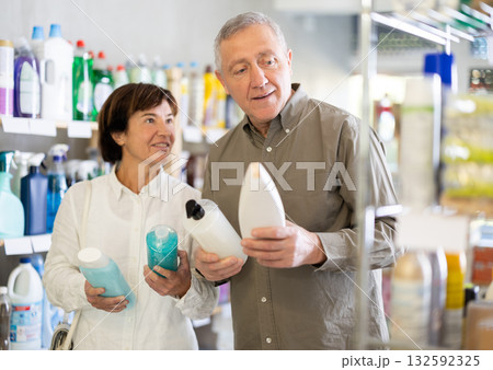 Couple man and woman choosing shampoo or shower gel in store Couple man and woman choosing shampoo or shower gel in store 132592325