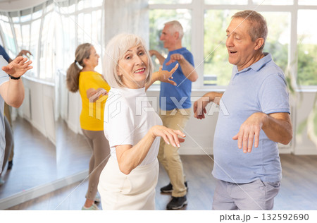 Couple of elderly man and woman dancing twist Couple of elderly man and woman dancing twist 132592690