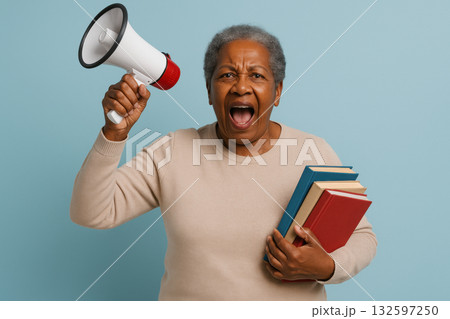 Elderly woman passionately speaking through megaphone holding books, advocating for education and community awareness on blue background, AI Generative 132597250