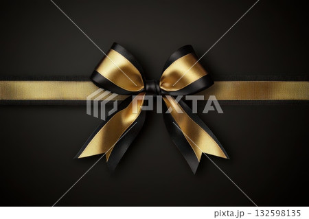 Elegant Black and Gold Ribbon Bow on Dark Background for Gift or Decoration Purposes 132598135