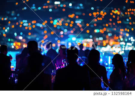 A group of people are standing outside at night A group of people are standing outside at night 132598164