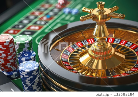 A gold colored roulette wheel with a gold colored ball on top of it A gold colored roulette wheel with a gold colored ball on top of it 132598194