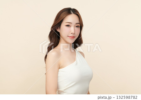 A beautiful young Asian woman with clean, fresh skin against a beige background. Skincare, facial treatment, cosmetology, beauty, and spa. An elegant portrait of an Asian woman. A beautiful young Asian woman with clean, fresh skin against a beige background. Skincare, facial treatment, cosmetology, beauty, and spa. An elegant portrait of an Asian woman. 132598782