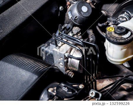 Close up of car ABS module in engine bay 132599226