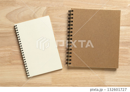two blank spiral notebook on wooden table for mockup blank template 132601727