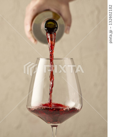 closeup of red wine pouring in glass 132602182