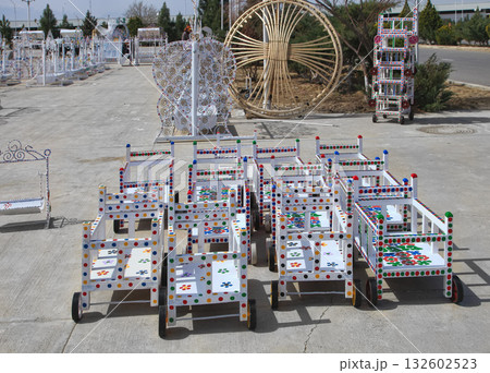 Turkmenistan. Ashkhabad market. Handmade baby carriages with colorful ornaments. Turkmenistan. Ashkhabad market. Handmade baby carriages with colorful ornaments. 132602523