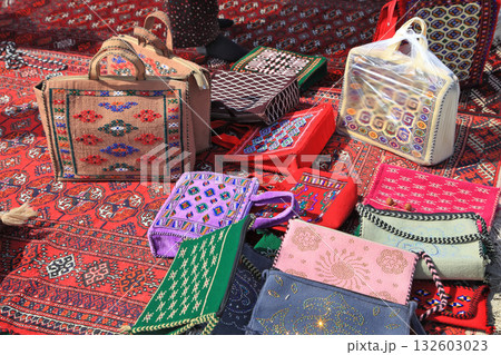 Handmade decorative bags and carpets with traditional ornament. Turkmenistan. Ashkhabad market. 132603023