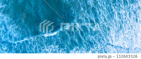 Ocean surf. Waves roll onto the shore. View from above. Horizontal banner 132603326