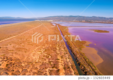 Salt lake in the Cabo de Gata nature reserve at sunset. Salt flats of Cabo de Gata. Drone view. Almeria Spain Salt lake in the Cabo de Gata nature reserve at sunset. Salt flats of Cabo de Gata. Drone view. Almeria Spain 132603449