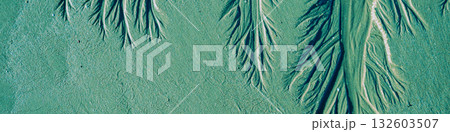 Abstract sandy beach background. Sand texture after low tide on the beach. Horizontal banner. Green tinting 132603507