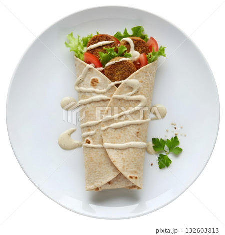 Delicious vegetarian falafel wrap with lettuce, tomato, and tahini sauce on white plate, fresh healthy meal Delicious vegetarian falafel wrap with lettuce, tomato, and tahini sauce on white plate, fresh healthy meal 132603813