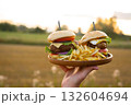Two hamburgers with beef burger cutlet, fried onion, ketchup sauce and cheese 132604694