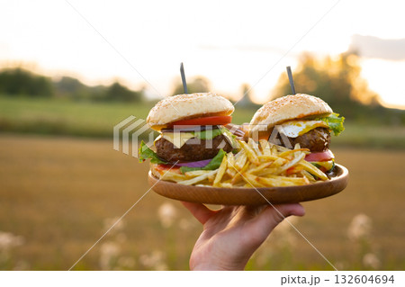 Two hamburgers with beef burger cutlet, fried onion, ketchup sauce and cheese 132604694