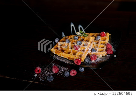 Belgian Liege waffles with berries, blueberrie Sweet breakfast dessert Belgian Liege waffles with berries, blueberrie Sweet breakfast dessert 132604695