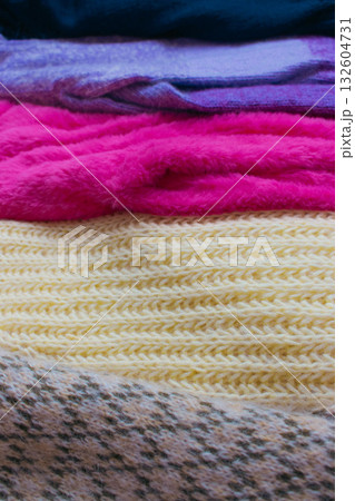 Stack of knitted sweaters. Different knitting patterns. Warm handmade clothes. Knitted sweater cardigans. Craft product concept. Winter fashion. Cozy woven clothing. Knitted fashion. Knitting hobby. Stack of knitted sweaters. Different knitting patterns. Warm handmade clothes. Knitted sweater cardigans. Craft product concept. Winter fashion. Cozy woven clothing. Knitted fashion. Knitting hobby. 132604731