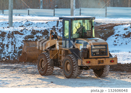 Yellow front loader wheeled tractor at a construction site at winter Yellow front loader wheeled tractor at a construction site at winter 132606048