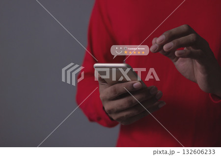 Customer Review, Young Man hand holding Smart Phone with five star to review and give 5 stars  132606233