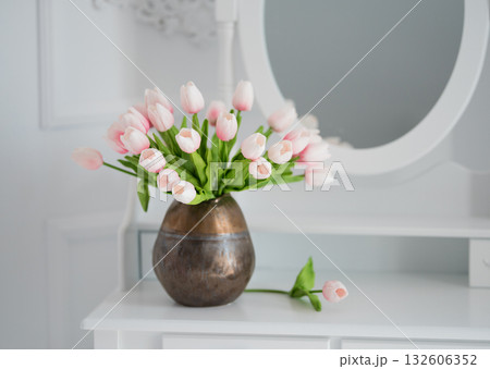artificial tulips on a table with a mirror 132606352