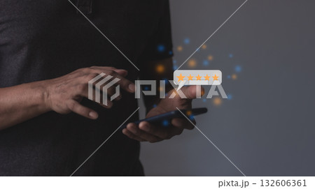Customer Review, Young Man hand holding Smart Phone with five star to review and give 5 stars Customer Review, Young Man hand holding Smart Phone with five star to review and give 5 stars 132606361