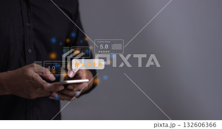 Customer Review, Young Man hand holding Smart Phone with five star to review and give 5 stars  132606366