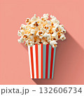 Delicious popcorn in a striped container on a bright background for snack lovers 132606734