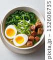 Delicious bowl of ramen with soft boiled eggs and fresh greens ready to enjoy at meal time 132606735