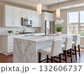 Modern kitchen design featuring marble island and sleek appliances. 132606737