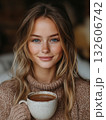 Young woman enjoys warm drink in cozy setting during winter 132606742