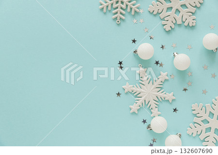 White Christmas Ornaments and Snowflakes on Light Blue Background White Christmas Ornaments and Snowflakes on Light Blue Background 132607690