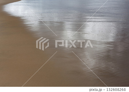 The sea is receding from the shore The sea is receding from the shore 132608268