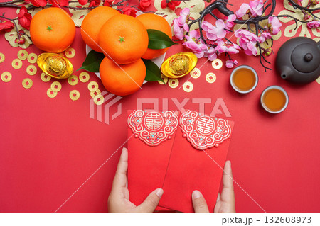 Chinese New Year celebration with oranges and red envelopes 132608973
