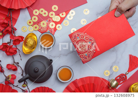 Chinese New Year red envelope and tea setup with gold coins Chinese New Year red envelope and tea setup with gold coins 132608975