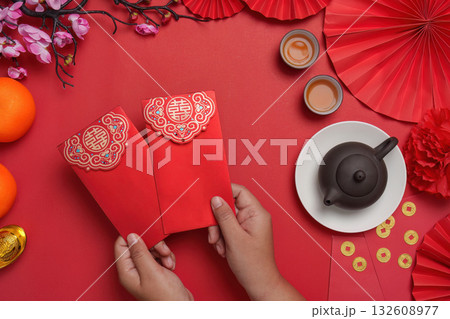Chinese New Year celebration with red envelopes and tea Chinese New Year celebration with red envelopes and tea 132608977
